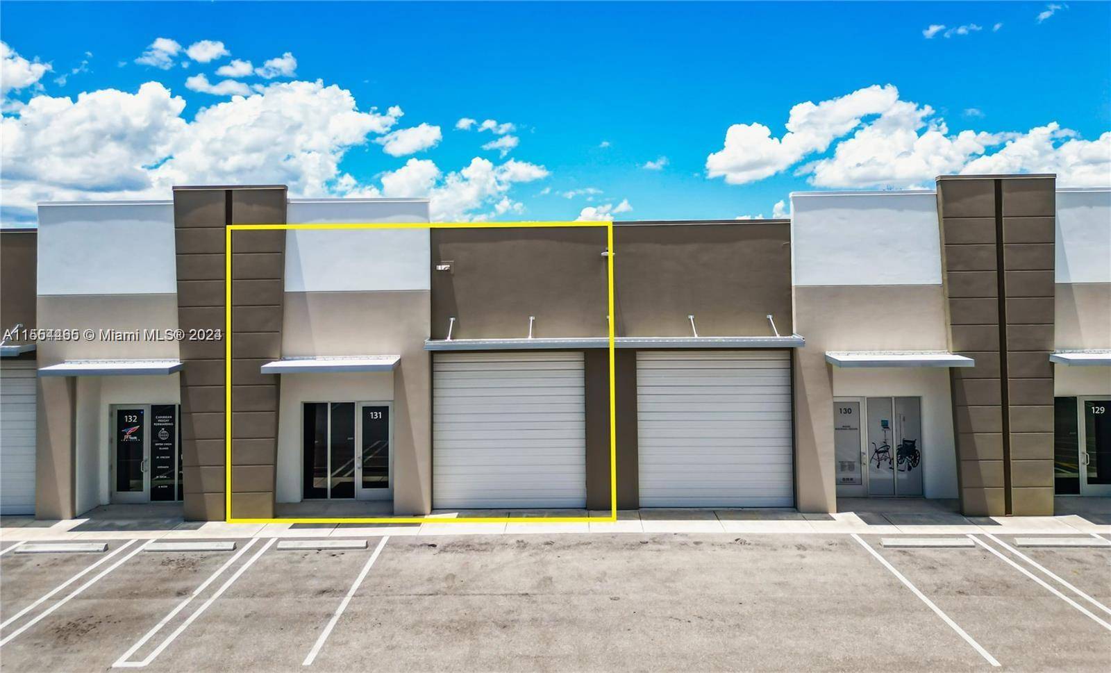 Newer Construction Industrial Flex Space Condo for Lease Warehouse features a private office space with reception area, 18 ft ceilings, glass storefront, shared parking spaces, bathroom, modern lighting grade level ...