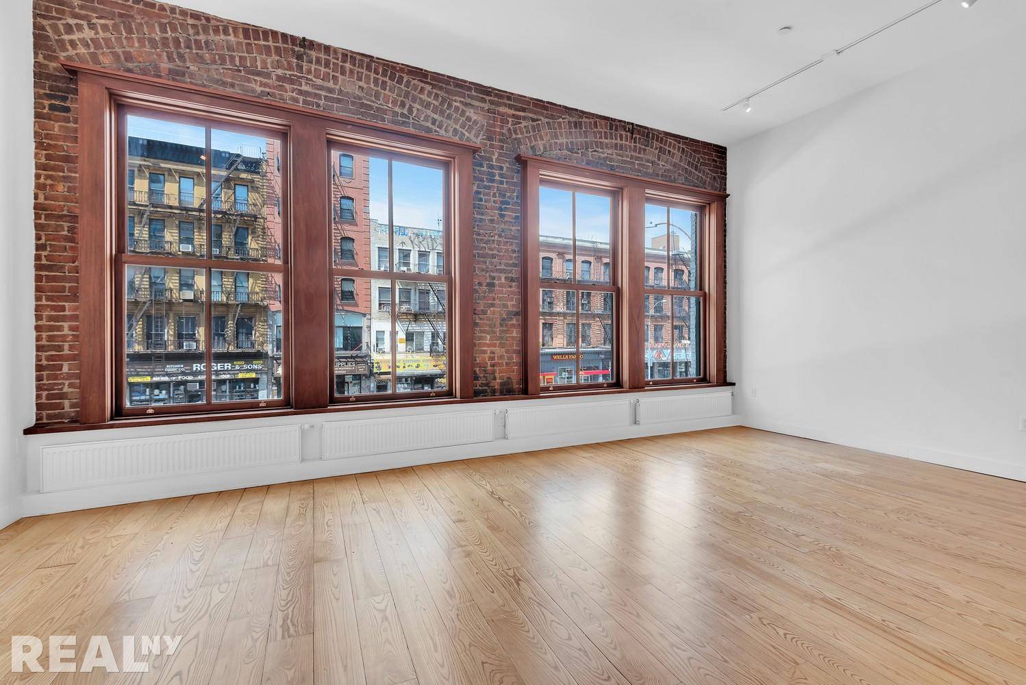 Enter your dream loft on the Lower East side with oversized windows and an expansive living room made to create the perfect environment to relax at home.