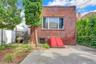 Back of house featuring brick siding and a patio area