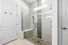 Frameless double-head shower with a built-in bench—spacious, stylish, and spa-inspired.