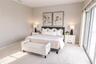 Spacious primary suite with elevated water views and private balcony.