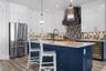Kitchen with new stainless appliances including a gas range