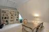 Carpeted office with lofted ceiling and ornamental molding