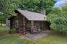 Authentic log cabin interior showcasing original timber construction and period character