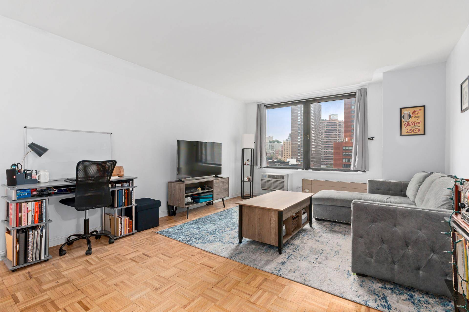 This is a renovated and spacious studio with bright northwestern views of the city skyline and oversized windows.