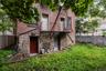 Back of house with brick siding and stone siding