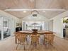 Guests always enjoy congregating in the kitchen, but the large open wall between can be quickly sectioned off for the more formal dining occasions.