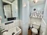 Bathroom featuring vanity, tile walls, and a wainscoted wall