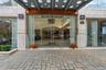 Modern building entrance featuring a stone-clad facade and automatic glass doors