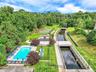 Beautiful grounds include tennis court and pool