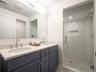 Bathroom with a shower stall and double vanity