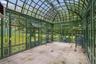 Imported Hartley Botanic greenhouse from England, creating an elegant glass pavilion for year-round growing, entertaining, or quiet retreat