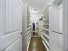 Primary bedroom walk-in closet