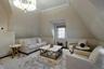 Bedroom featuring vaulted ceiling, light hardwood / wood-style flooring, a notable chandelier, and crown molding