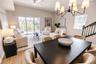 Open concept living and dining room with natural light and balcony overlooking mangroves.