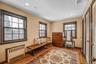 Living area featuring radiator, light wood-style flooring, healthy amount of natural light, and recessed lighting