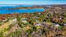 Aerial view of property and surrounding area with a nearby body of water
