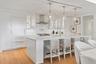 Custom frameless contemporary wood cabinetry with full-extension drawer glides, soft-close drawer and doors, complemented by under-cabinet lighting.