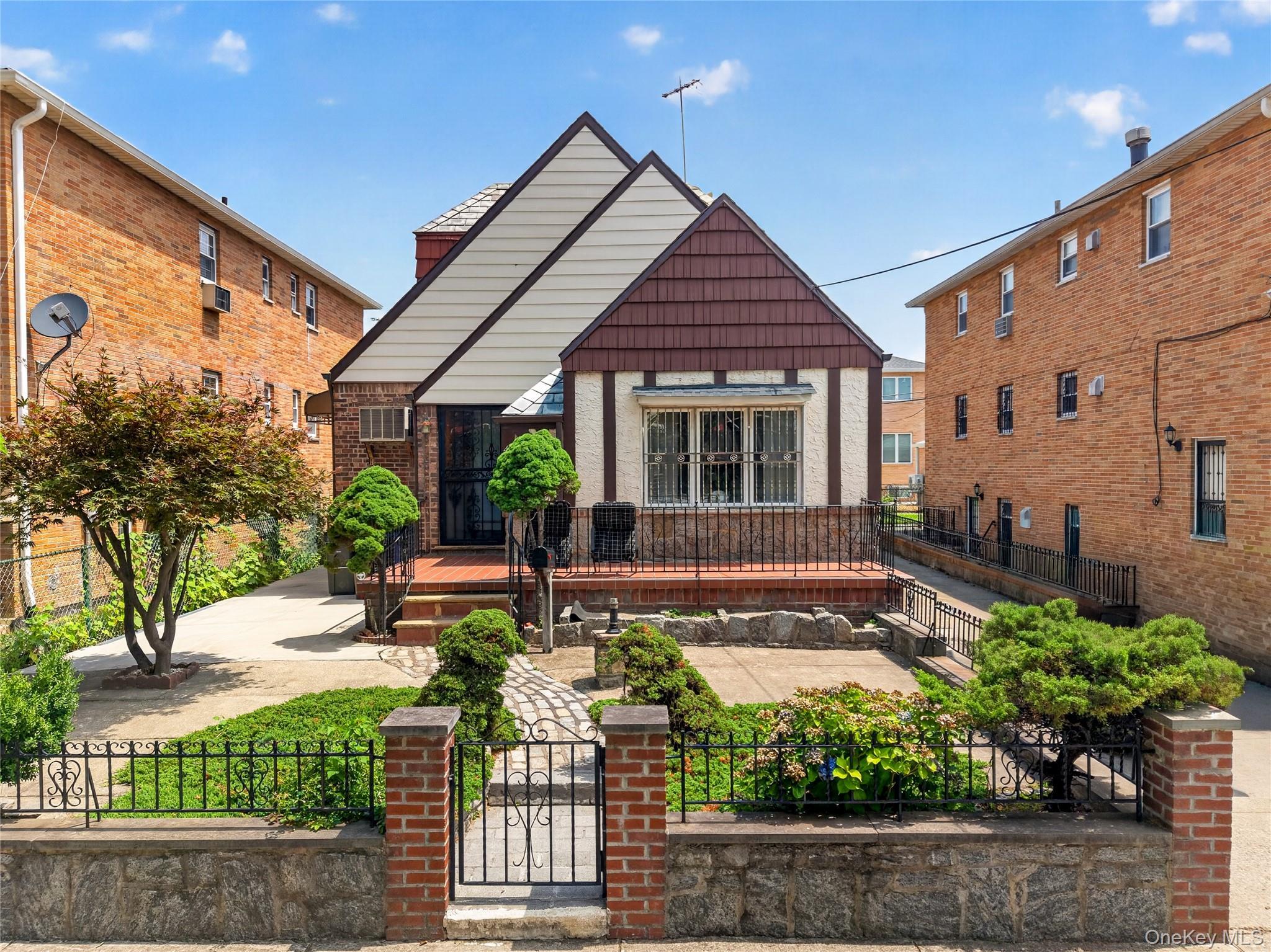 Tudor-style residence with a distinct gabled roofline and a brick and stucco exterior