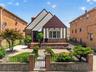 Tudor-style residence with a distinct gabled roofline and a brick and stucco exterior