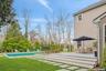 View of yard featuring an outdoor pool and a deck