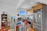 Kitchen featuring light wood-style flooring, a sink, backsplash, stainless steel appliances, and extractor fan