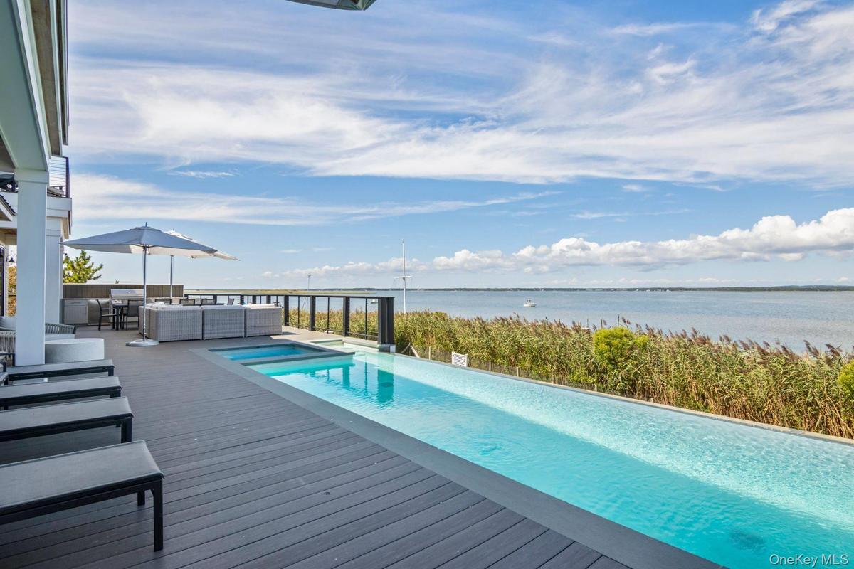 Waterviews from heated Gunite Infinity Edge Saltwater Pool with infinity edge & built in Spa