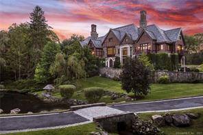 This extraordinary stone, brick and slate European manor style residence is prominently sited above a lovely free flowing pond on 4 acres in a prime mid country location.