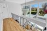 Stairway with hardwood / wood-style floors and baseboards