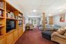 Living area with dark carpet and a paneled ceiling