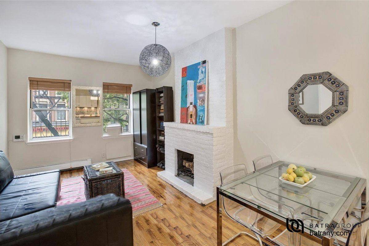 Beautiful and sunny Pre War studio in East HarlemWood burning brick fireplace and hardwood floors throughout !