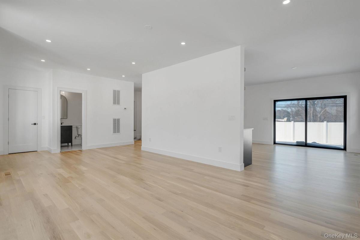 Spacious and open living area filled with natural sunlight from oversized windows, designed for both everyday comfort and entertaining.
