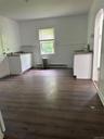 Kitchen with dark hardwood / wood-style flooring and white cabinetry