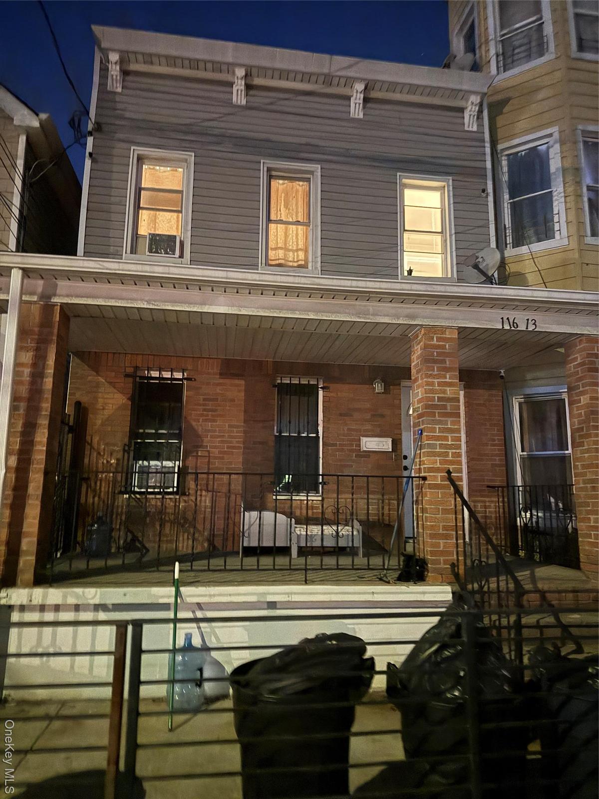 View of front facade featuring a porch and brick siding