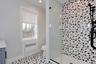 Full bath featuring vanity, a shower stall, and radiator heating unit