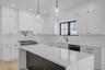 Thoughtfully designed kitchen featuring clean finishes, modern cabinetry, and an open layout that connects seamlessly to the dining area and main livi