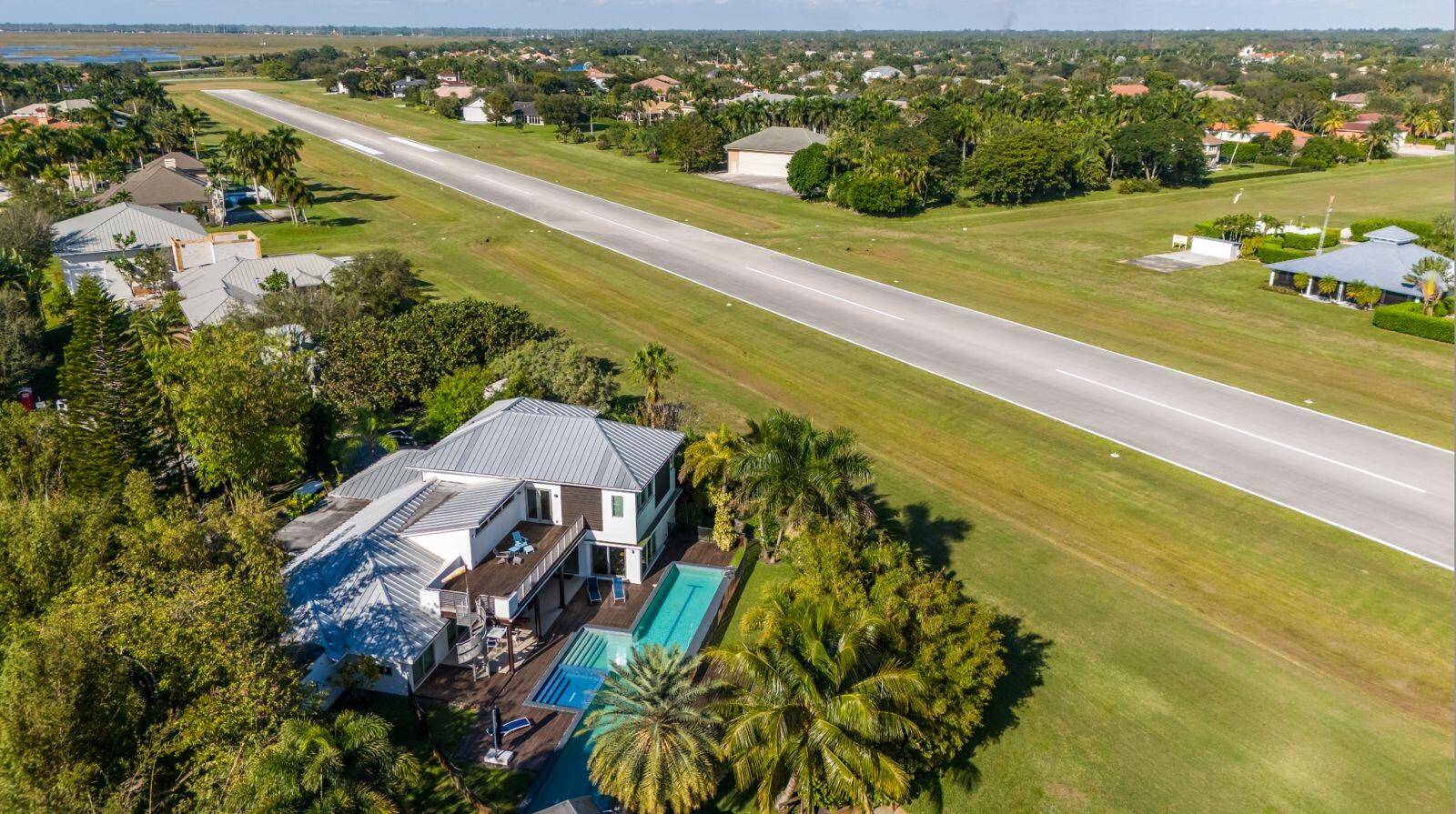 Custom estate home located directly on the runway of South Florida's premier aeronautical community.