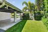 This is the West side elevation of the Carport, the yard is partially fenced in . The side and rear yards have recently installed artificial turf, no