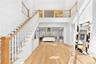Entryway with wood finished floors, a towering ceiling, and stairs