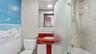 Full bathroom featuring tile walls, vanity, shower / bath combination with curtain, and tasteful backsplash