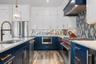 Kitchen with new stainless appliances including a gas range