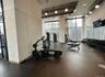 Workout area with a high ceiling and expansive windows