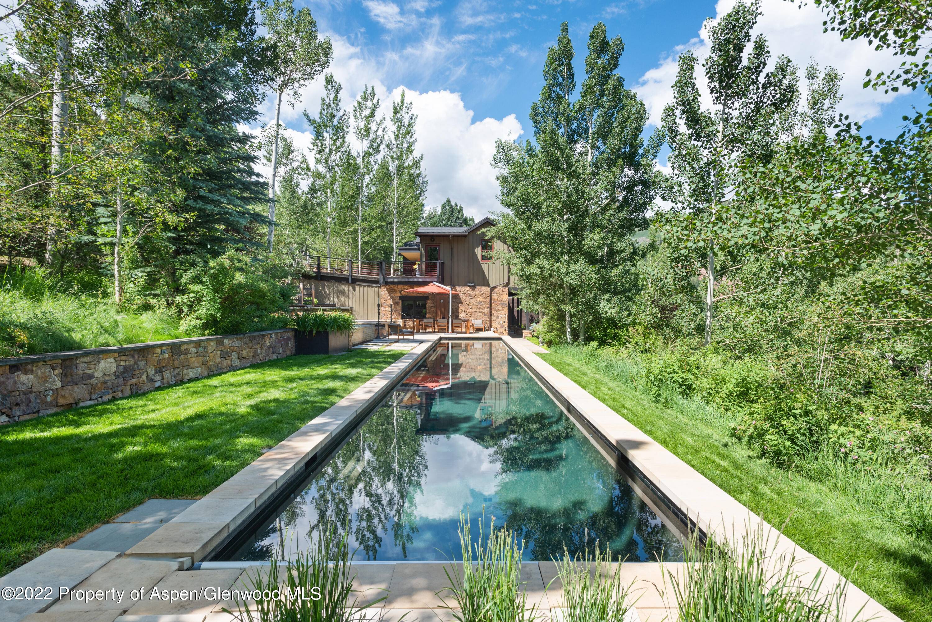 On one of the most desirable lots in highly coveted Five Trees, this extraordinary mountain contemporary estate sits on an acre parcel overlooking the Aspen valley.