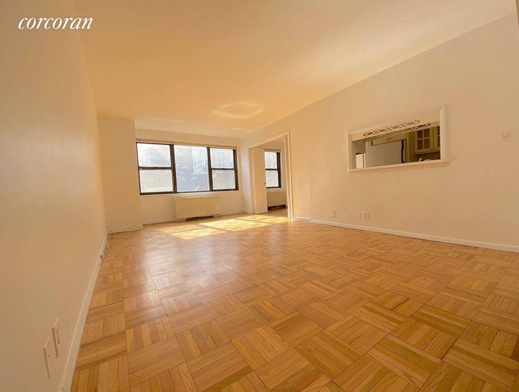 Enjoy all day sun and open views from this wonderful SW corner converted two bedroom apartment with hardwood floors throughout, and windows in all rooms !