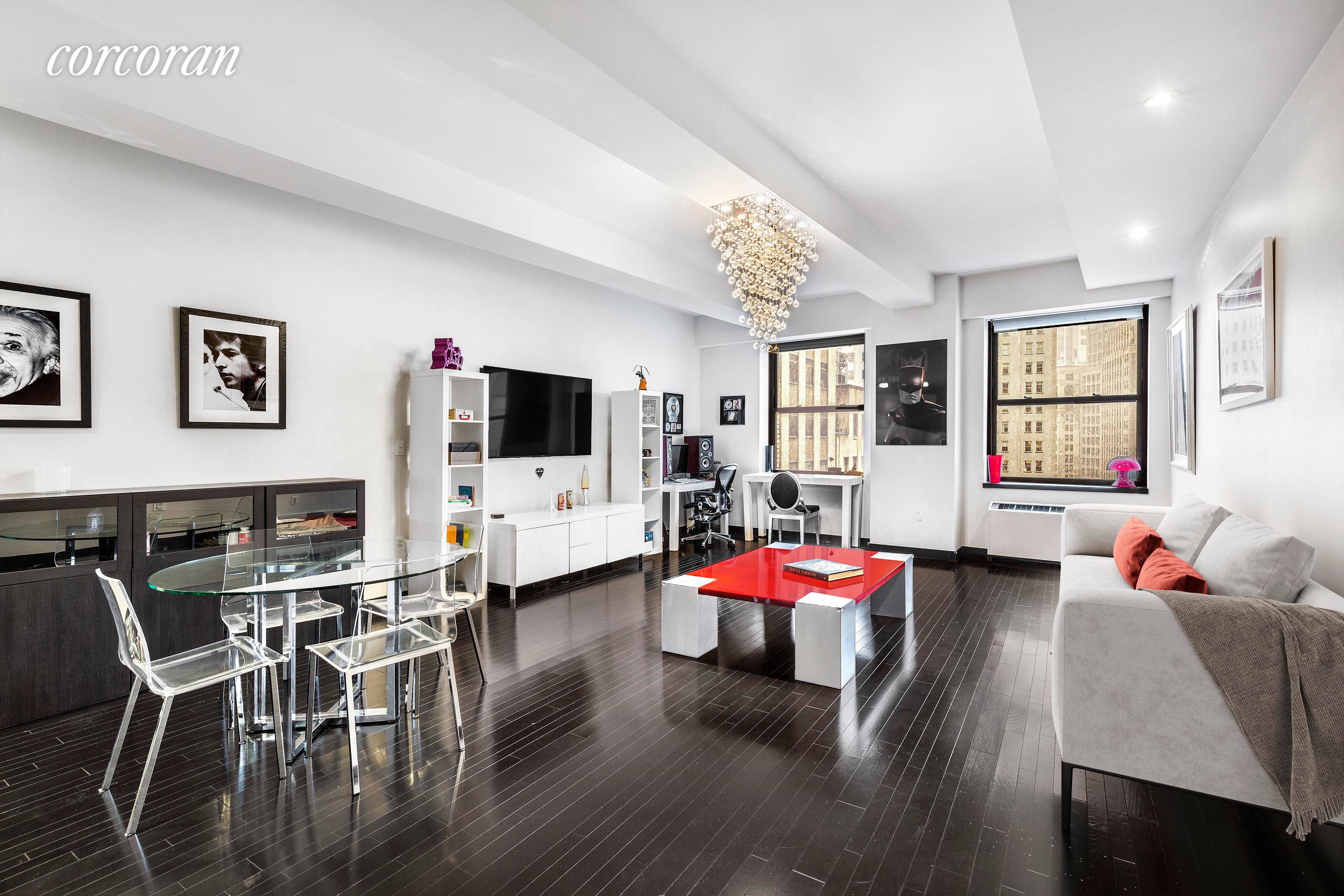 Oversized windows provide unobstructed views of the stunning New York Stock Exchange building in this bright, beautiful and grand one bedroom loft at the coveted condominium 20 Pine Street.