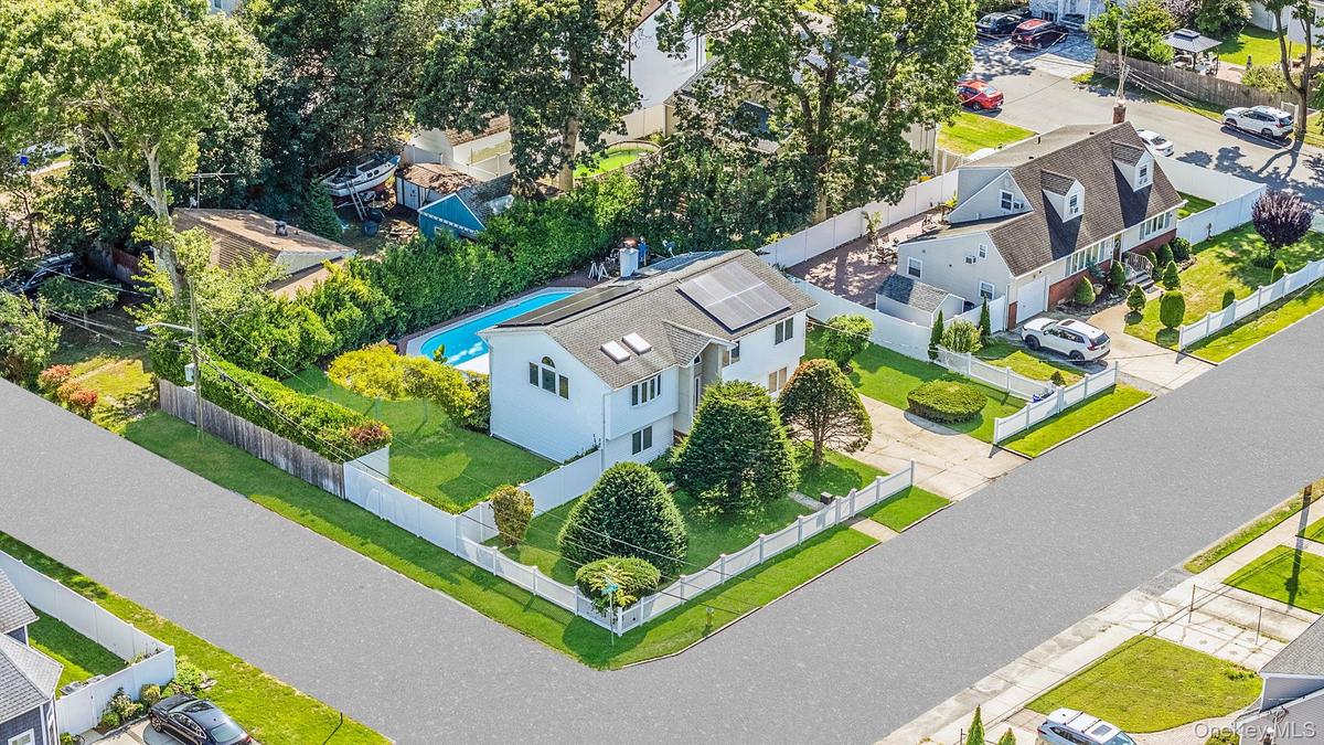 Aerial view of residential area featuring a pool