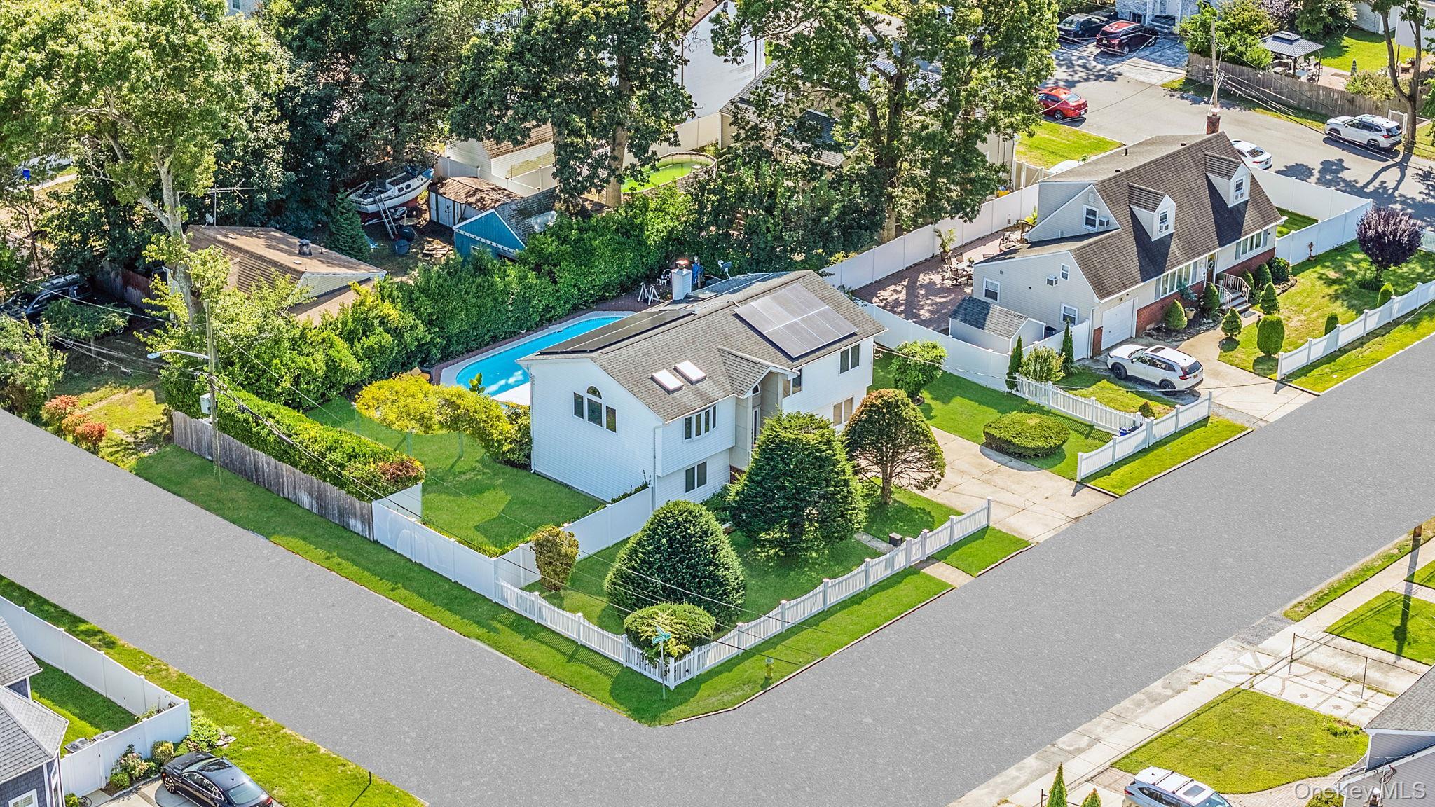 Aerial view of residential area featuring a pool