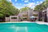 View of swimming pool featuring a grill