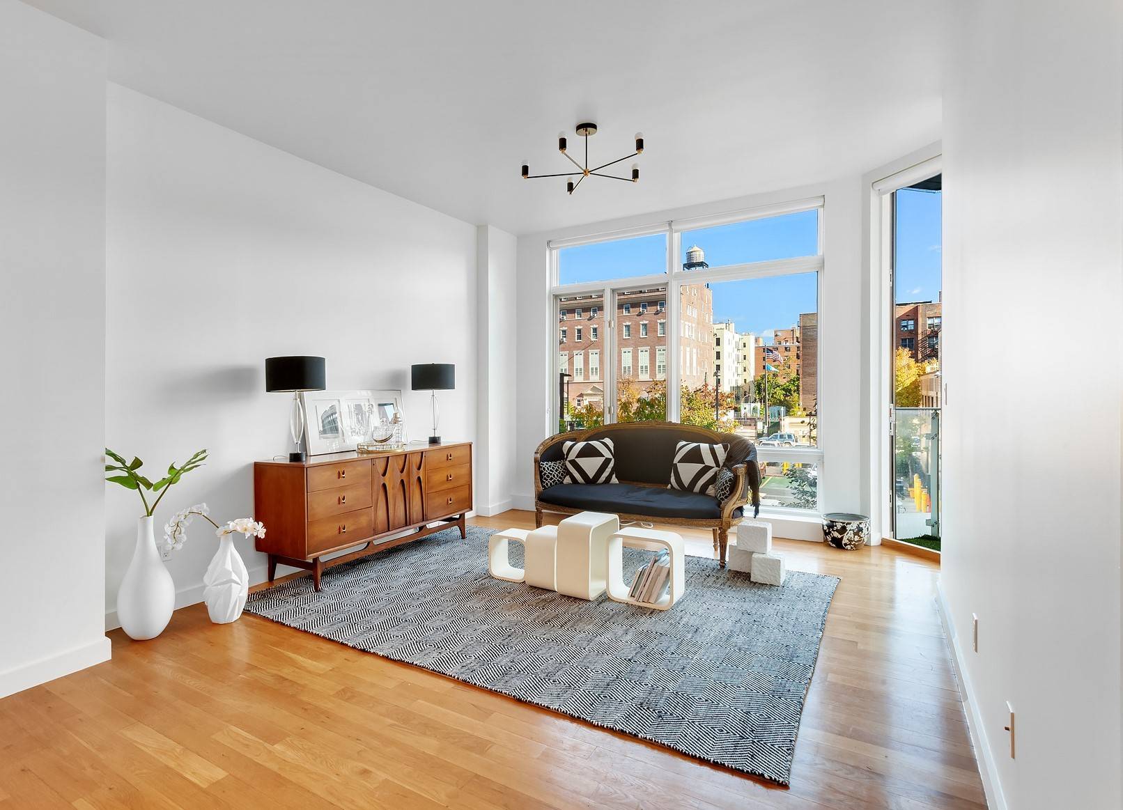 Stunning one bedroom apartment with open sky views, a private balcony, and floor to ceiling windows.