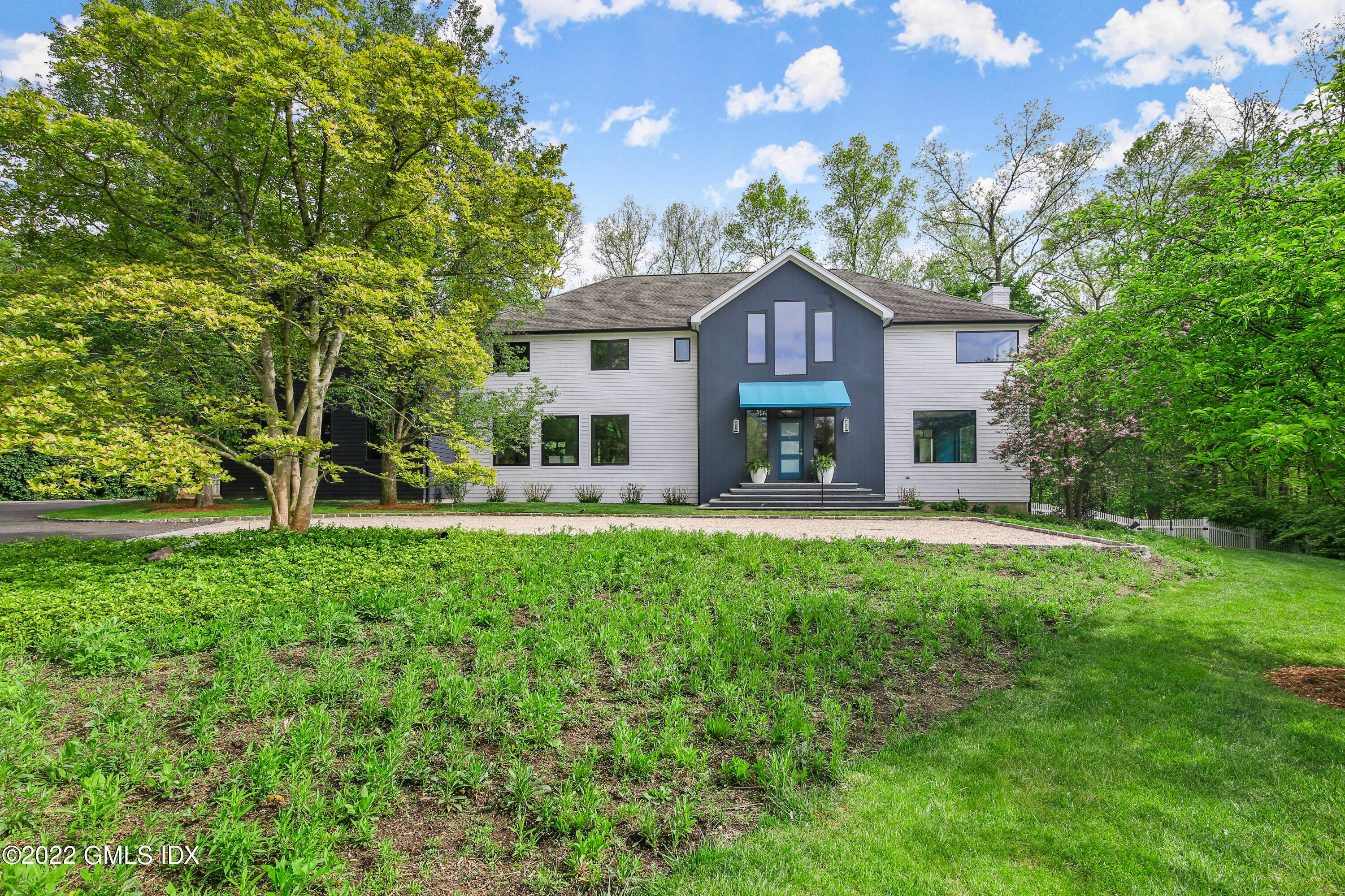 Set off a wide private lane bordered by truly magnificent grounds of adjoining great estates, this transformed five bedroom colonial is now a sleek and uniquely private retreat.